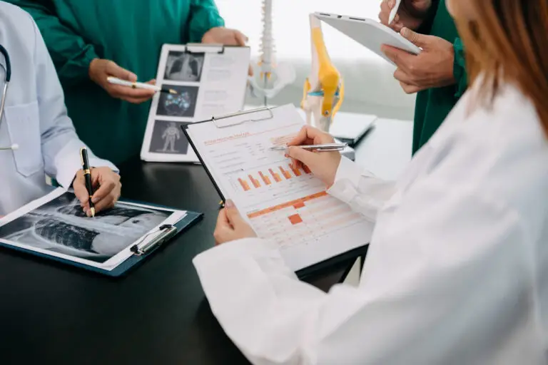 Doctors reviewing medical charts and X-rays.